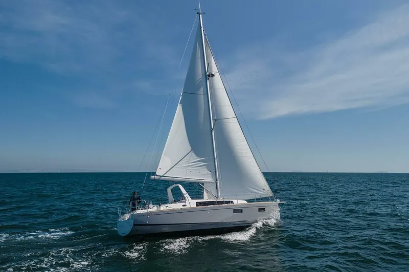 Slide: The Image of 2023 Beneteau Oceanis 38.1 sailing on open sea under clear blue sky. - 96