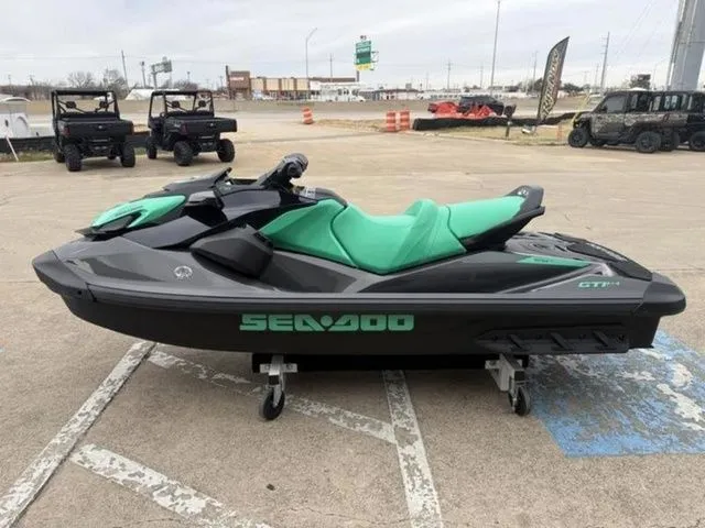 Slide: The Image of 2026 Sea-Doo GTI SE 170 jet ski with green seat on parking lot. - 5