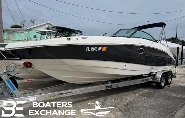 The Image of 2018 NauticStar 243 DC Deck boat on trailer. - 1