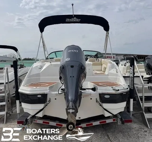 Slide: The Image of 2018 NauticStar 243 DC Deck boat with outboard motor. - 2