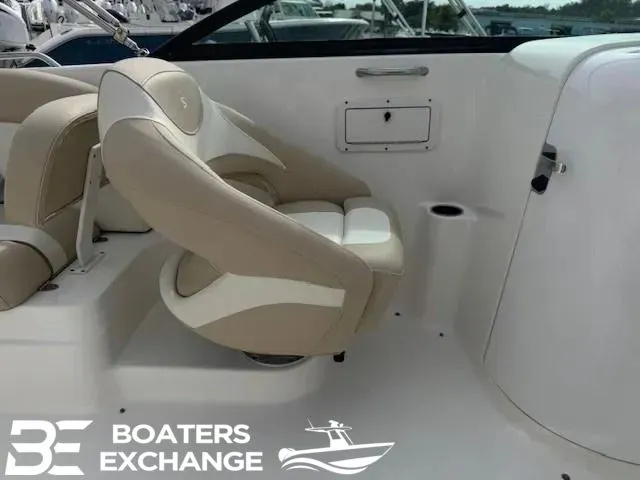 Slide: The Image of Interior of a 2018 NauticStar 243 DC Deck boat with beige seating. - 6