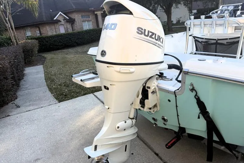 Slide: The Image of 2019 Bulls Bay 2000 boat with Suzuki outboard motor in driveway. - 13