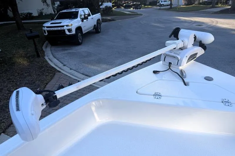 Slide: The Image of 2019 Bulls Bay 2000 boat with trolling motor, parked white truck in background. - 16