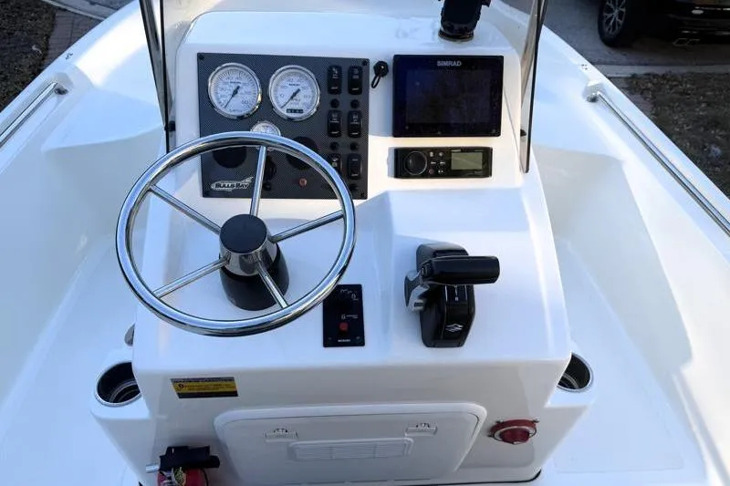 Slide: The Image of 2019 Bulls Bay 2000 boat console with steering wheel, gauges, and navigation equipment. - 25