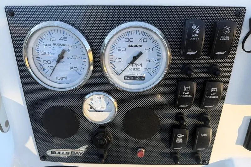 Slide: The Image of Dashboard of 2019 Bulls Bay 2000 boat with Suzuki gauges and control switches. - 27