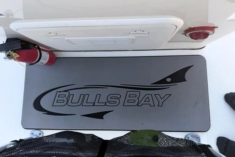 Slide: The Image of 2019 Bulls Bay 2000 boat deck with logo, fire extinguisher, and storage compartment. - 29