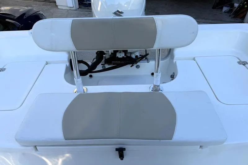 Slide: The Image of 2019 Bulls Bay 2000 boat seating area with cushioned backrest and storage compartments. - 36