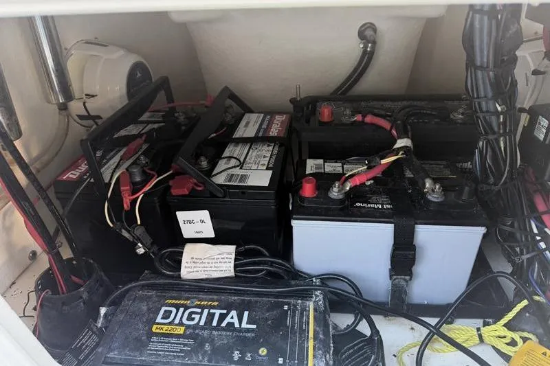 Slide: The Image of Bulls Bay 2000 boat battery compartment with multiple batteries and wiring, 2019 model. - 39