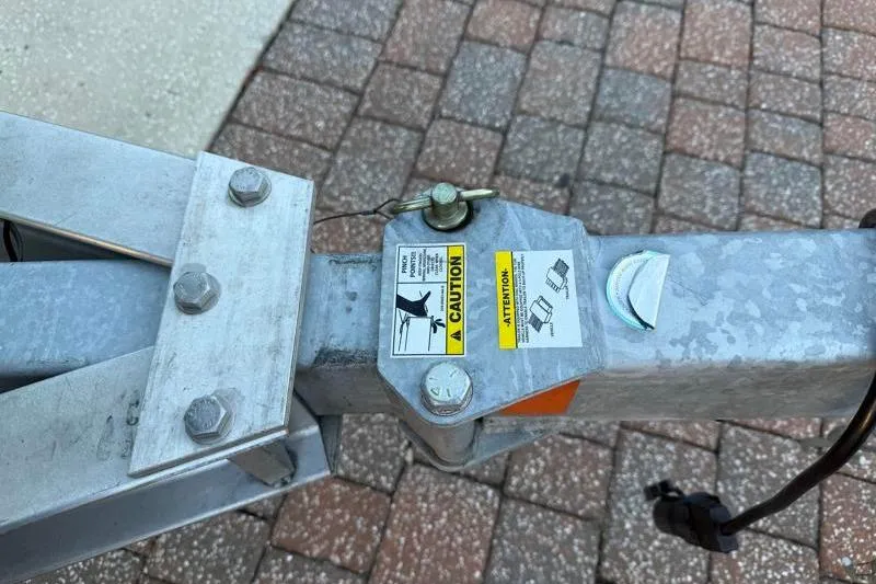 Slide: The Image of Trailer hitch with caution labels on a 2019 Bulls Bay 2000 boat trailer. - 45
