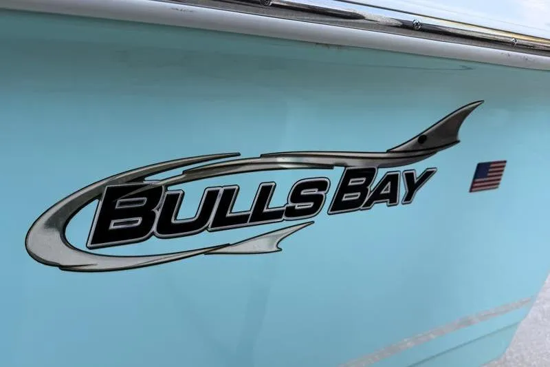 Slide: The Image of 2019 Bulls Bay 2000 boat logo on light blue hull with American flag decal. - 48