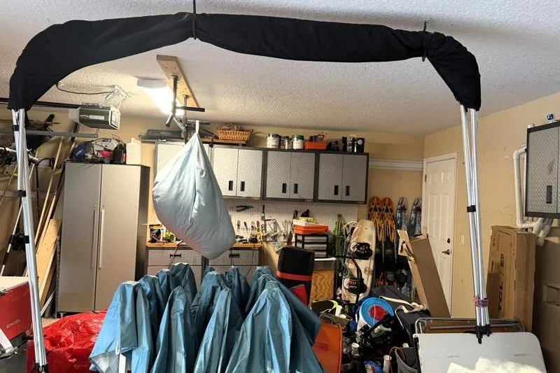 Slide: The Image of Garage with Bulls Bay 2000 boat canopy, storage shelves, and various equipment. - 49