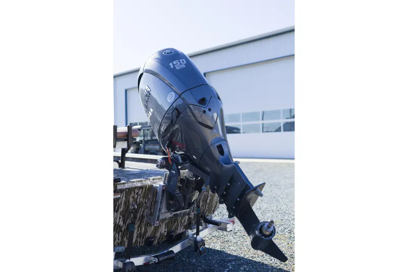 Slide: The Image of Outboard motor on Avid 20 Rogue CC boat, 2026 model, parked outdoors. - 12