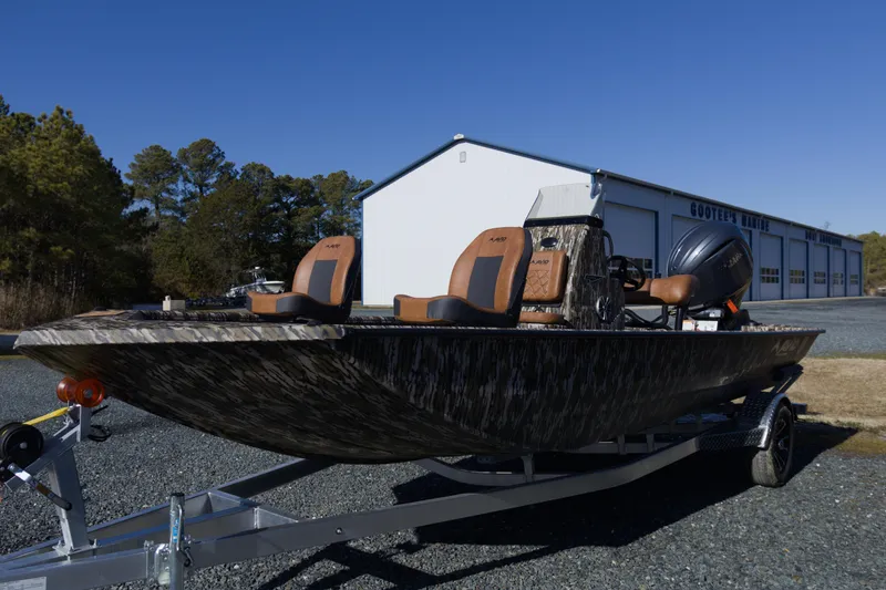 Slide: The Image of 2026 Avid 20 Rogue CC boat on trailer, parked outside a marine dealership. - 3