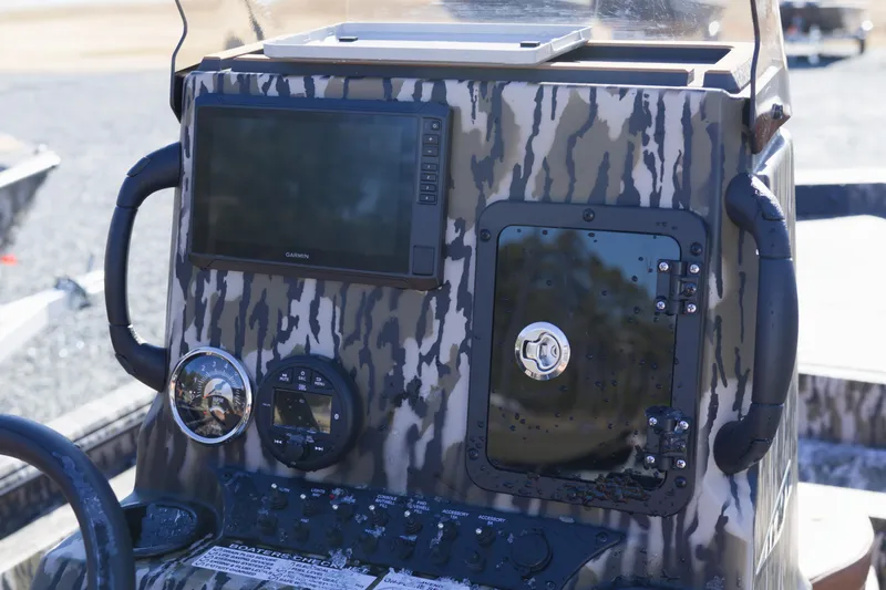 Slide: The Image of 2026 Avid 20 Rogue CC boat console with Garmin display and camouflage design. - 7