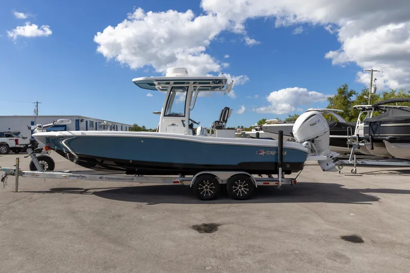 Slide: The Image of 2024 Crevalle 26 HCO boat with Yamaha engine on trailer, parked outdoors. - 11