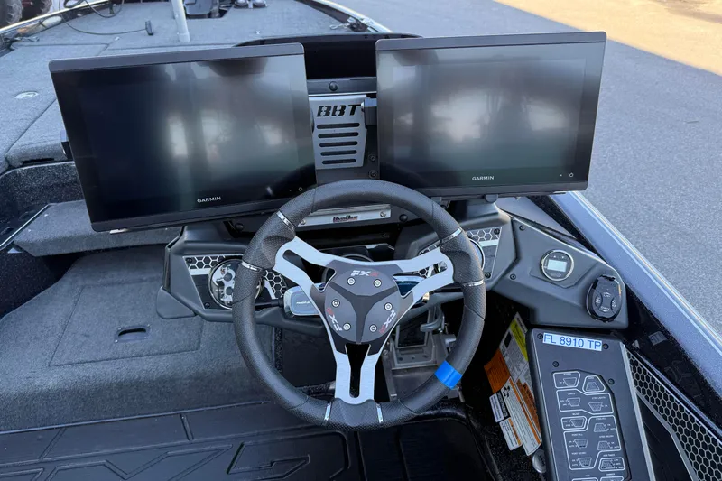 Slide: The Image of 2023 Skeeter FXR20 Select boat dashboard with dual Garmin displays and steering wheel. - 11