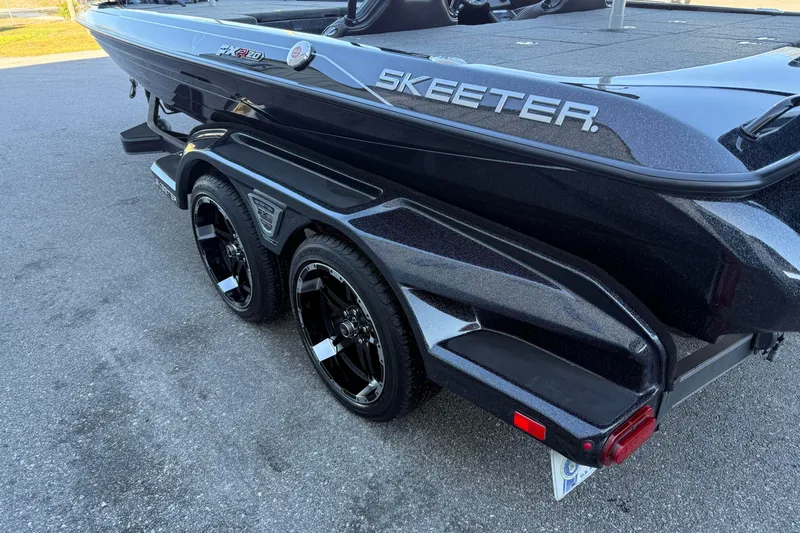 Slide: The Image of 2023 Skeeter FXR20 Select boat on trailer, showcasing sleek design and dual wheels. - 3