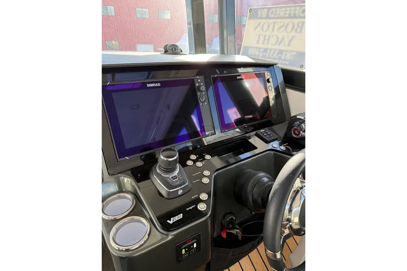 Slide: The Image of 2024 Schaefer V33 yacht with sleek design and luxurious seating, docked near coastal buildings. - 11