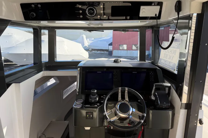 Slide: The Image of 2024 Schaefer V33 boat cockpit with modern steering and navigation controls. - 21