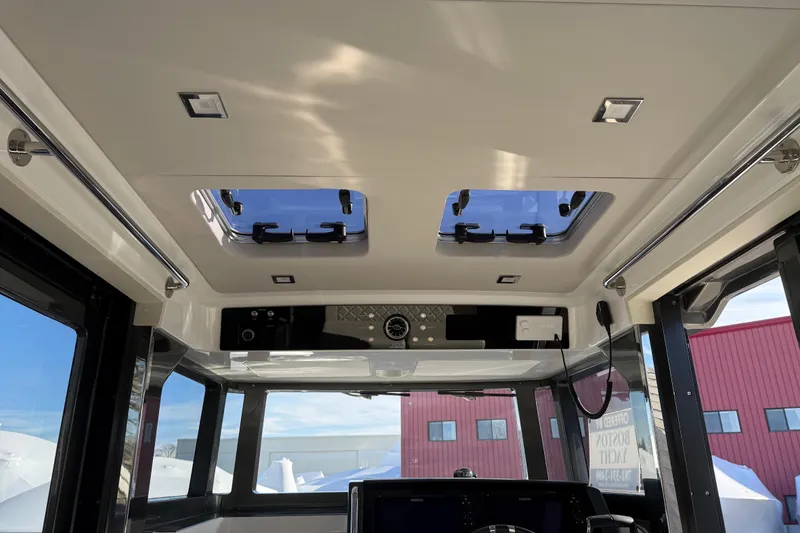 Slide: The Image of Interior view of 2024 Schaefer V33 boat with skylights and modern controls. - 22