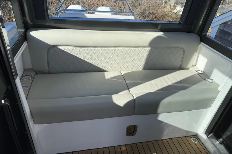 Slide: The Image of Luxurious seating on 2024 Schaefer V33 boat with elegant upholstery and cup holders. - 23