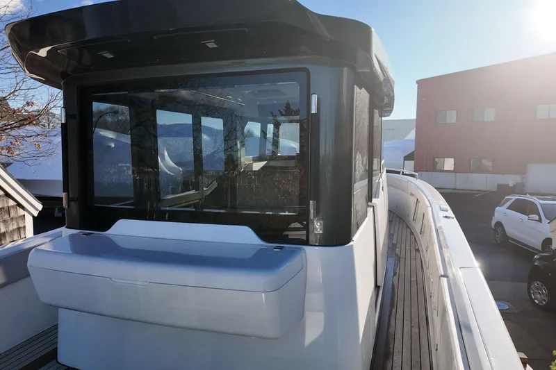 Slide: The Image of 2024 Schaefer V33 yacht with sleek design and modern windows, docked in a sunny marina. - 3