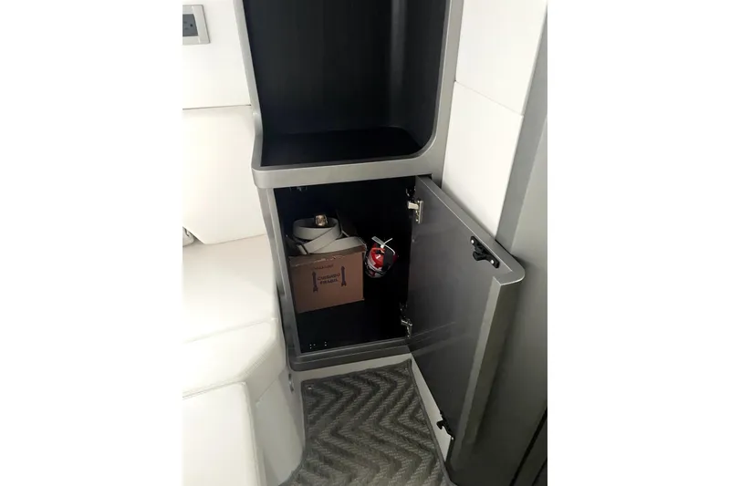 Slide: The Image of 2024 Schaefer V33 interior storage compartment with open door, showing safety equipment. - 30