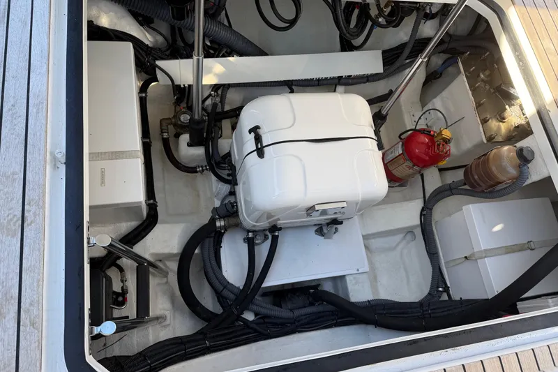 Slide: The Image of Engine compartment of 2024 Schaefer V33 boat with fire extinguisher and wiring. - 31