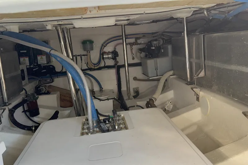 Slide: The Image of Engine compartment of 2024 Schaefer V33 boat, showcasing mechanical components and piping. - 33