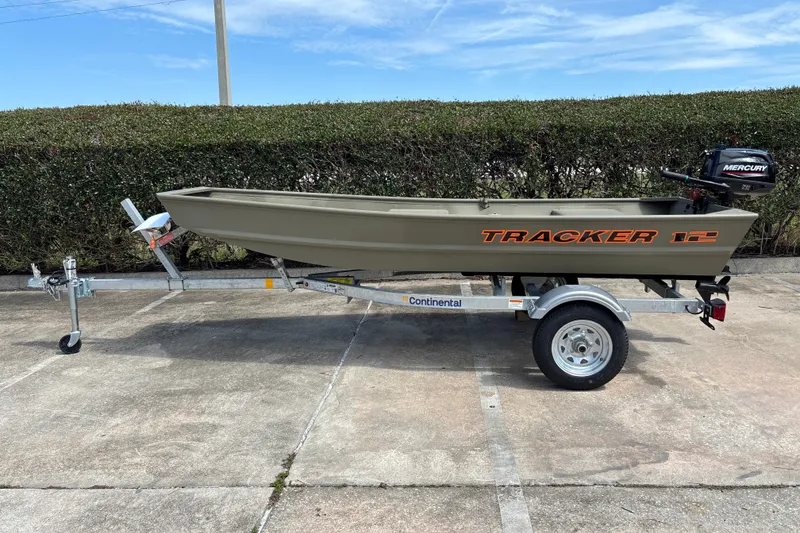 The Image of 2026 Tracker Grizzly 12 Jon boat on trailer with Mercury outboard motor. - 0