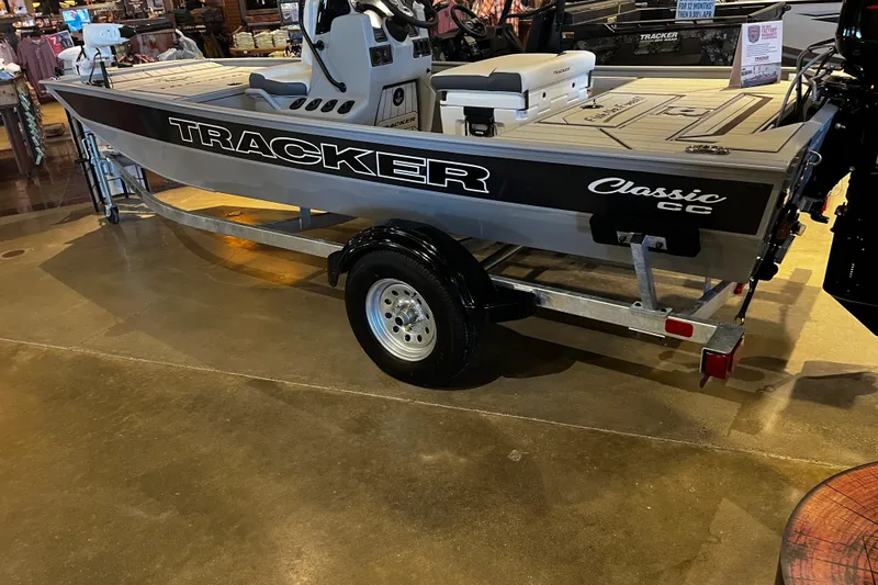 The Image of 2026 Tracker Bass Tracker Classic CC boat displayed indoors on a trailer. - 0