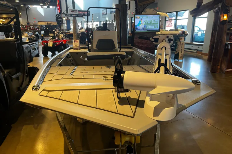 Slide: The Image of 2026 Tracker Bass Tracker Classic CC boat displayed indoors, featuring modern design and equipment. - 2