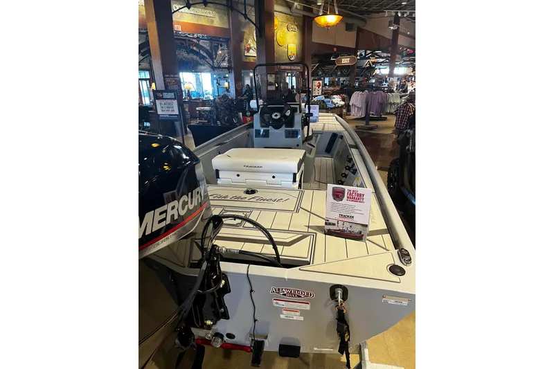 Slide: The Image of 2026 Tracker Bass Tracker Classic CC boat displayed indoors with Mercury engine. - 6