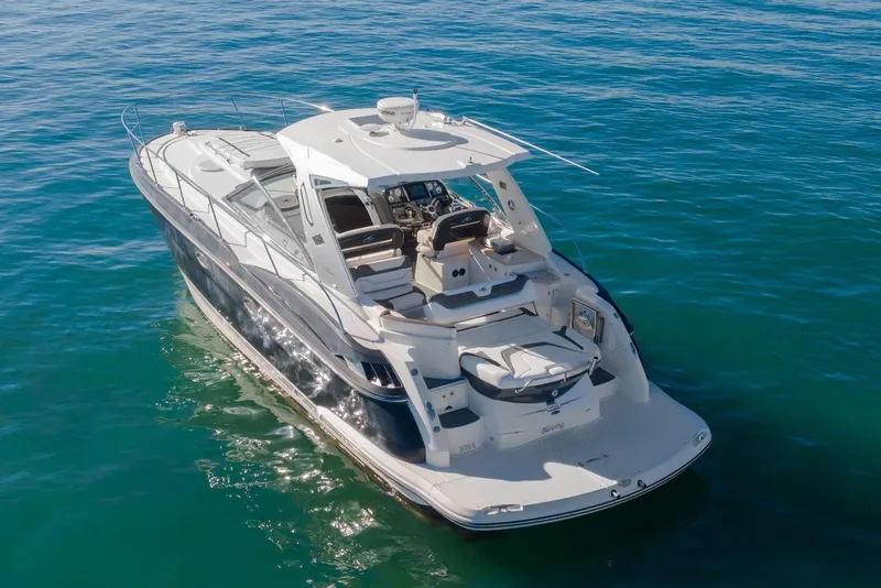 Slide: The Image of 2012 Monterey 400 Sport Yacht cruising on clear blue water. - 2