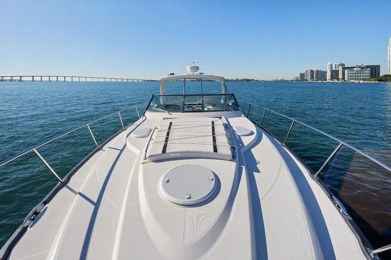 Slide: The Image of 2012 Monterey 400 Sport Yacht cruising on calm waters with city skyline in background. - 20