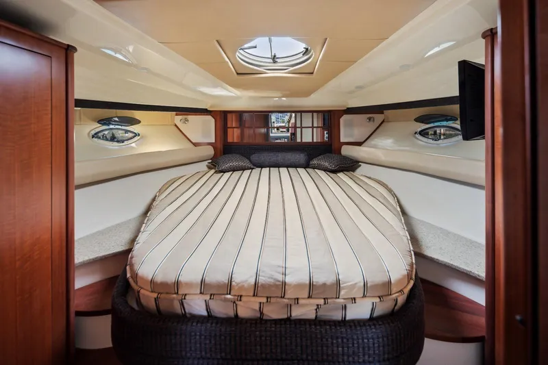 Slide: The Image of Luxurious interior cabin of 2012 Monterey 400 Sport Yacht with striped bedding. - 28
