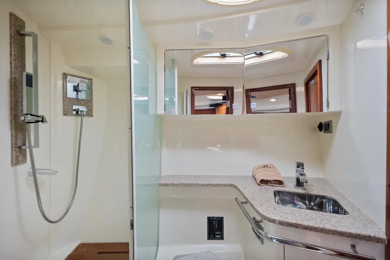 Slide: The Image of Luxurious bathroom in 2012 Monterey 400 Sport Yacht with modern fixtures and granite countertop. - 29