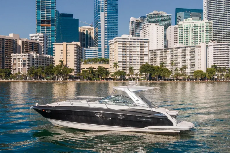 Slide: The Image of 2012 Monterey 400 Sport Yacht on water with city skyline backdrop. - 3