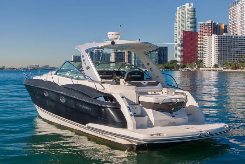 Slide: The Image of 2012 Monterey 400 Sport Yacht on water with city skyline backdrop. - 4