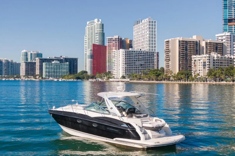 Slide: The Image of 2012 Monterey 400 Sport Yacht on water with city skyline backdrop. - 5
