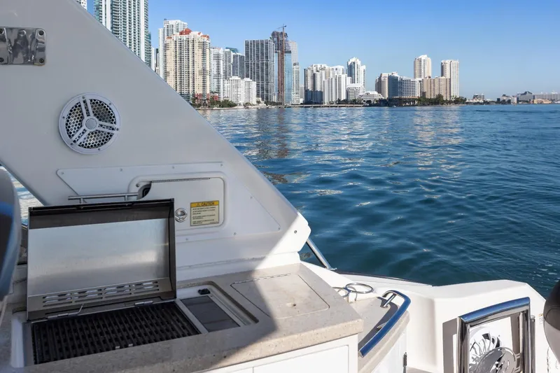 Slide: The Image of 2012 Monterey 400 Sport Yacht with grill, city skyline view, and calm waters. - 9