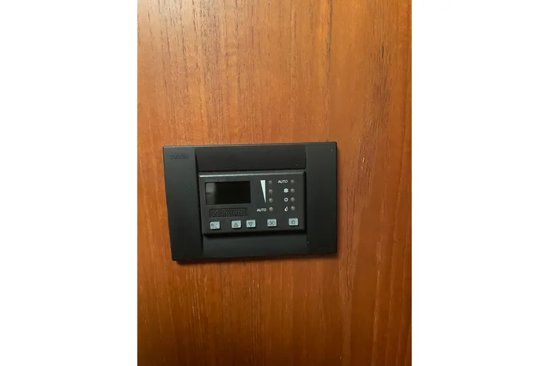 Slide: The Image of Control panel on 2006 Tiara Yachts 3800 Open, mounted on wooden surface. - 10