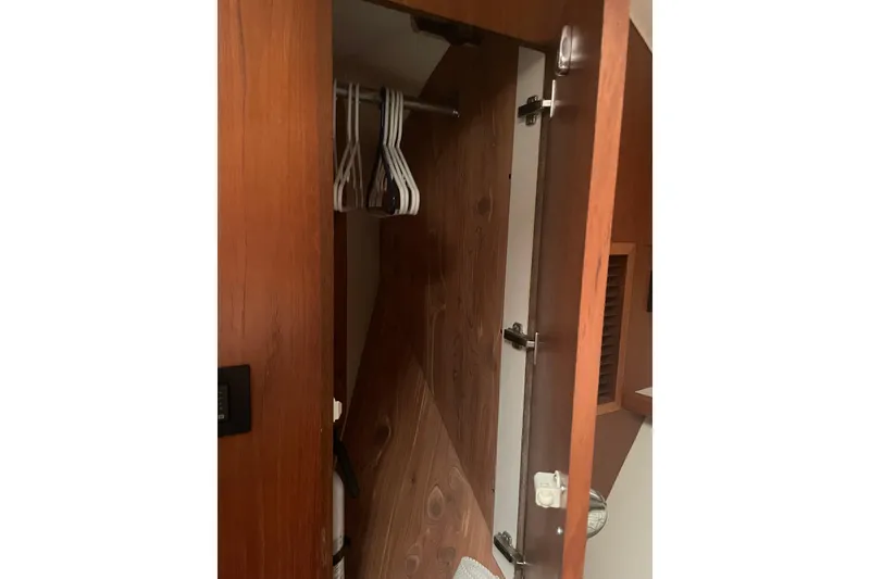 Slide: The Image of Open wooden closet with hangers inside Tiara Yachts 3800 Open, 2006 model. - 11