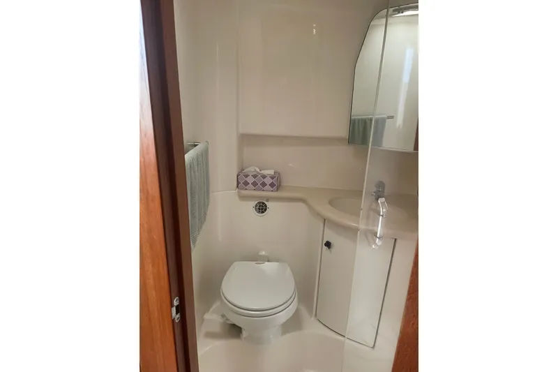 Slide: The Image of 2006 Tiara Yachts 3800 Open interior with bunk beds and blue cushions. - 14