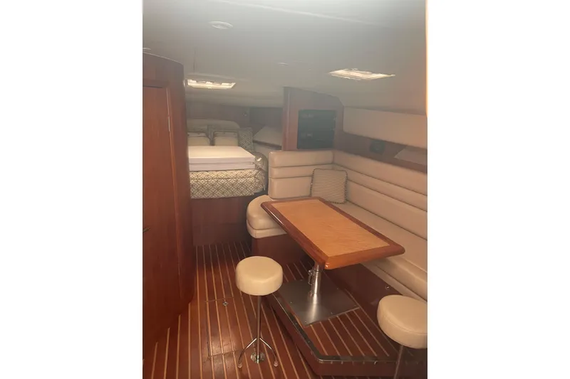Slide: The Image of 2006 Tiara Yachts 3800 Open galley with microwave, sink, and wooden cabinetry. - 16