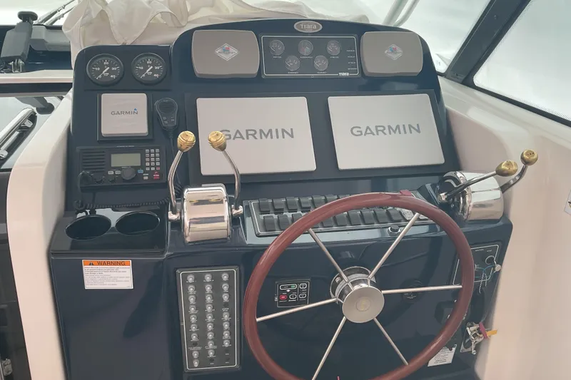 Slide: The Image of 2006 Tiara Yachts 3800 Open helm with Garmin navigation and classic wooden steering wheel. - 20