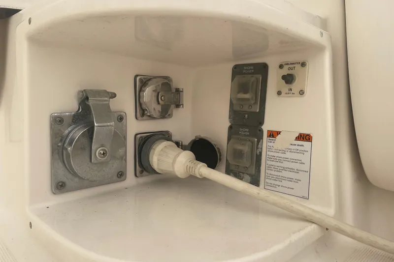 Slide: The Image of Electrical panel on a 2006 Tiara Yachts 3800 Open, featuring shore power connections. - 25
