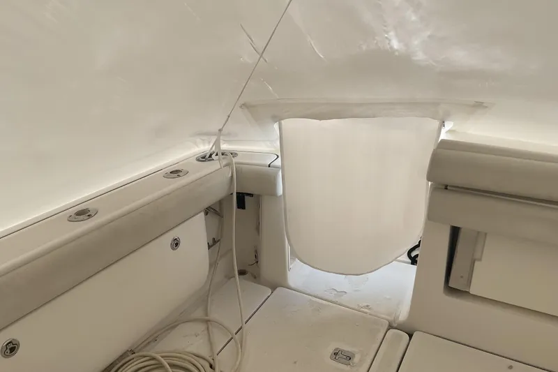 Slide: The Image of 2006 Tiara Yachts 3800 Open interior with white seating and storage compartments. - 29