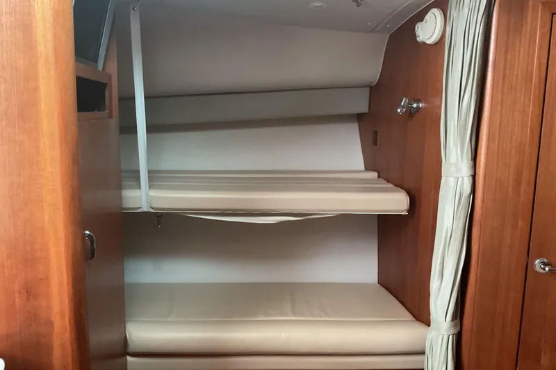 Slide: The Image of Interior cabin of 2006 Tiara Yachts 3800 Open with beige seating and wooden finish. - 4