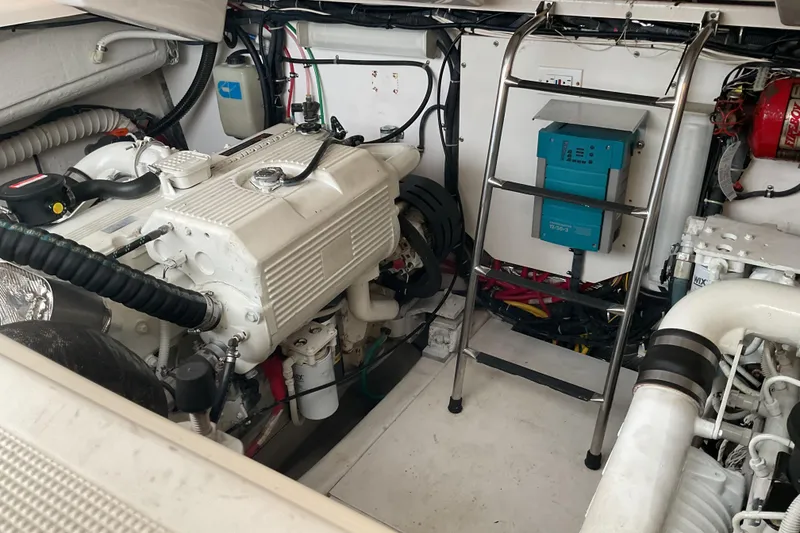 Slide: The Image of Engine room of a 2006 Tiara Yachts 3800 Open, showcasing mechanical components and fire extinguisher. - 43